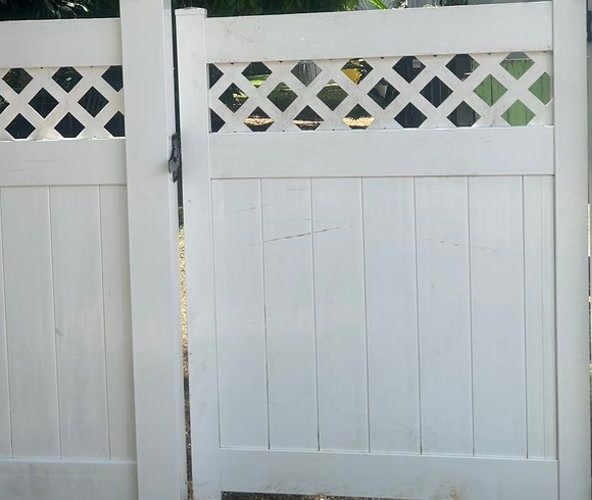 Vinyl fence after soft washing, clean and white.